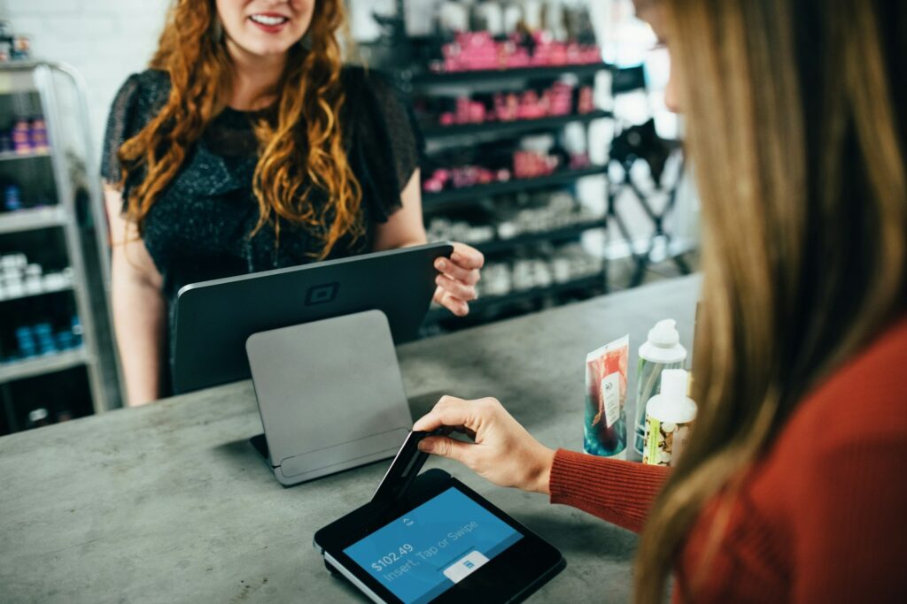 Customer at retail checkout using a loyalty rewards card