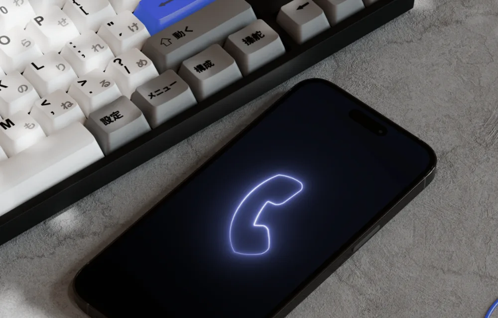 Smartphone with a glowing call icon on a desk - contact Khetta, web design and digital agency in Bahrain